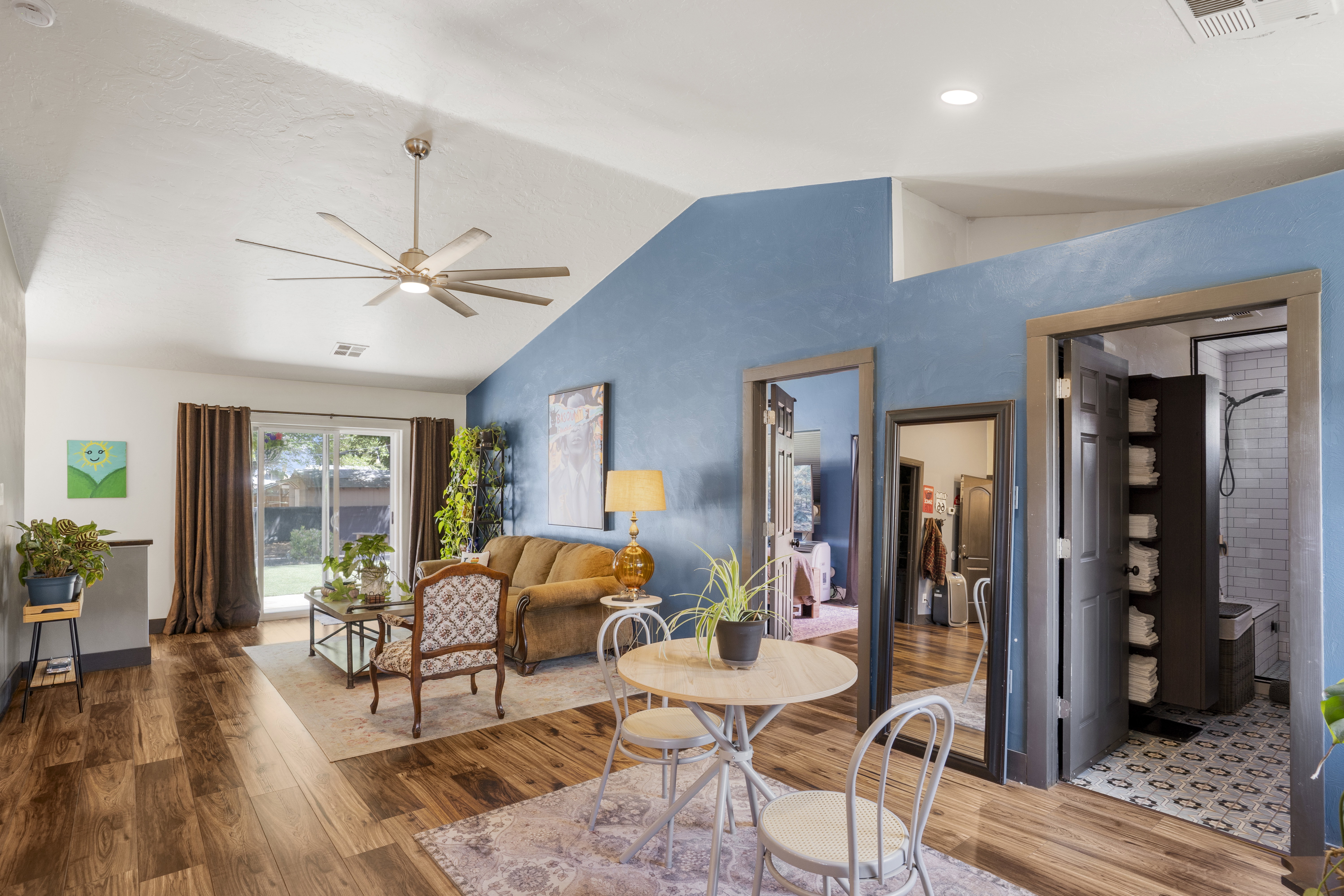 Living room with wood finished floors and ceiling fan