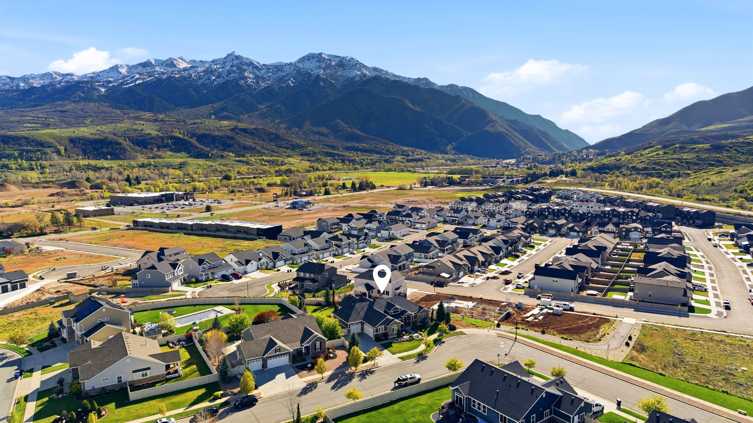 Aerial view of residential area featuring a mountainous background