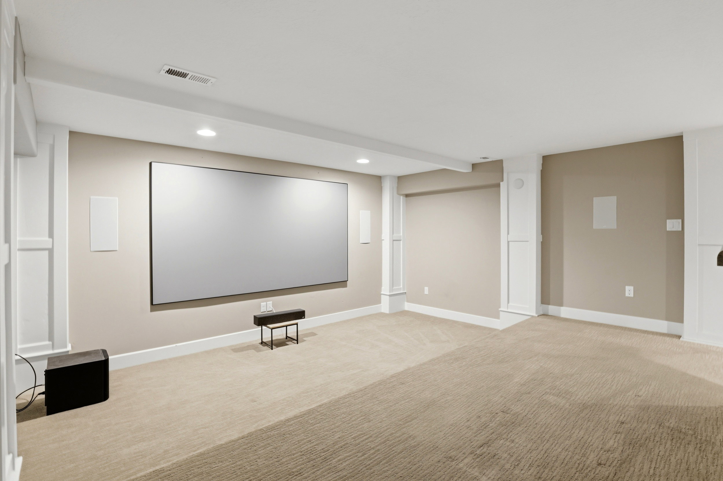 Cinema featuring recessed lighting and light colored carpet