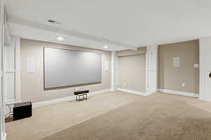 Cinema featuring recessed lighting and light colored carpet