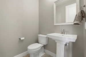 Bathroom with toilet and baseboards