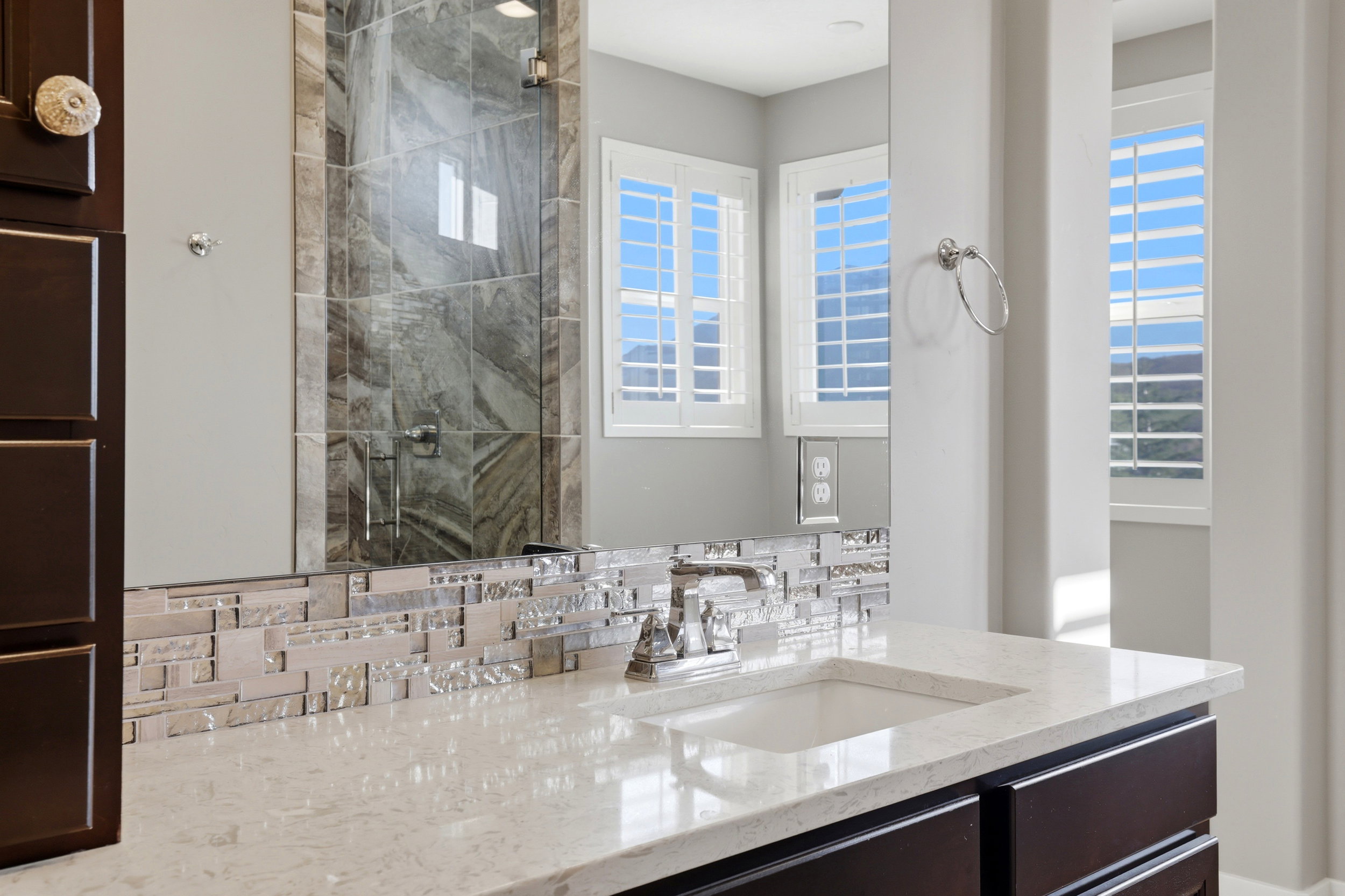 Full bathroom with vanity and a shower stall