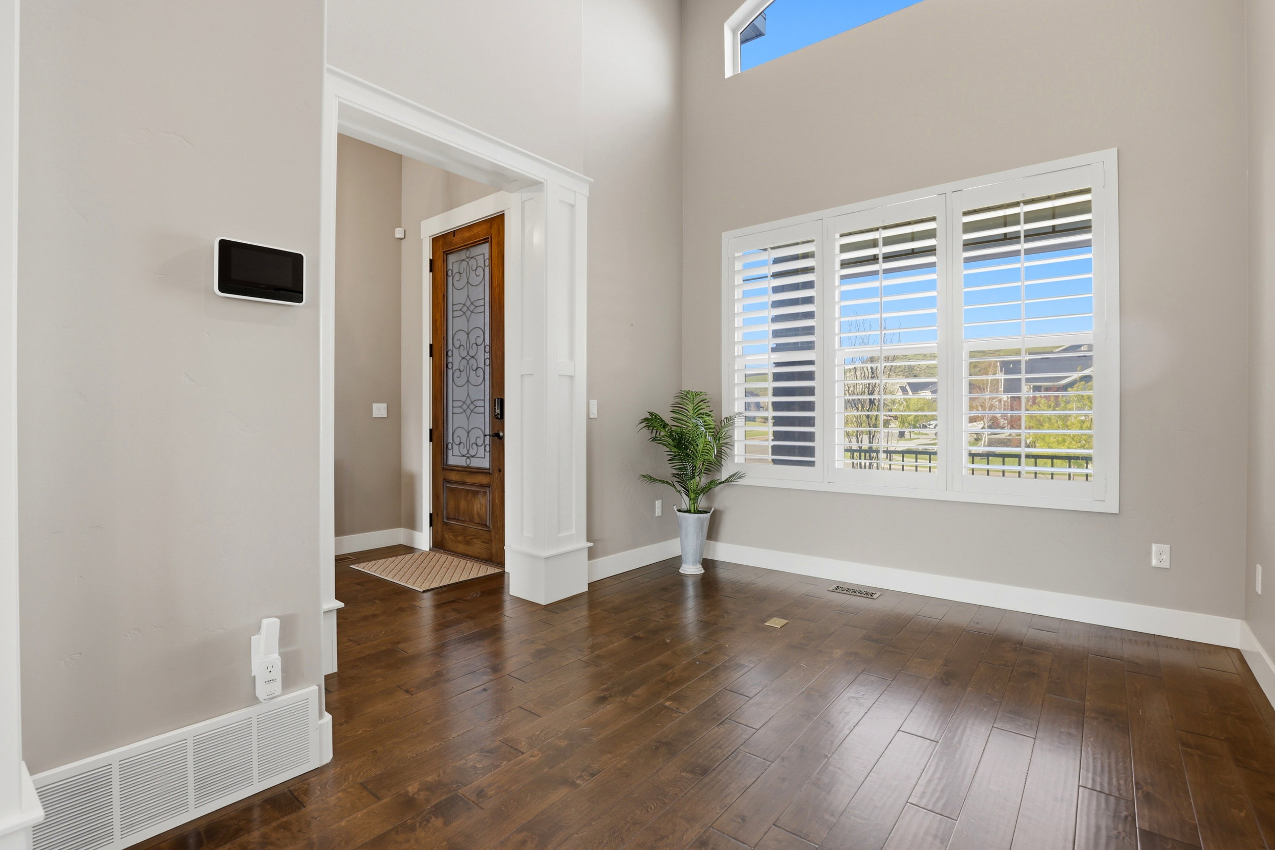 Foyer entrance featuring dark wood-style floors and a high ceiling
