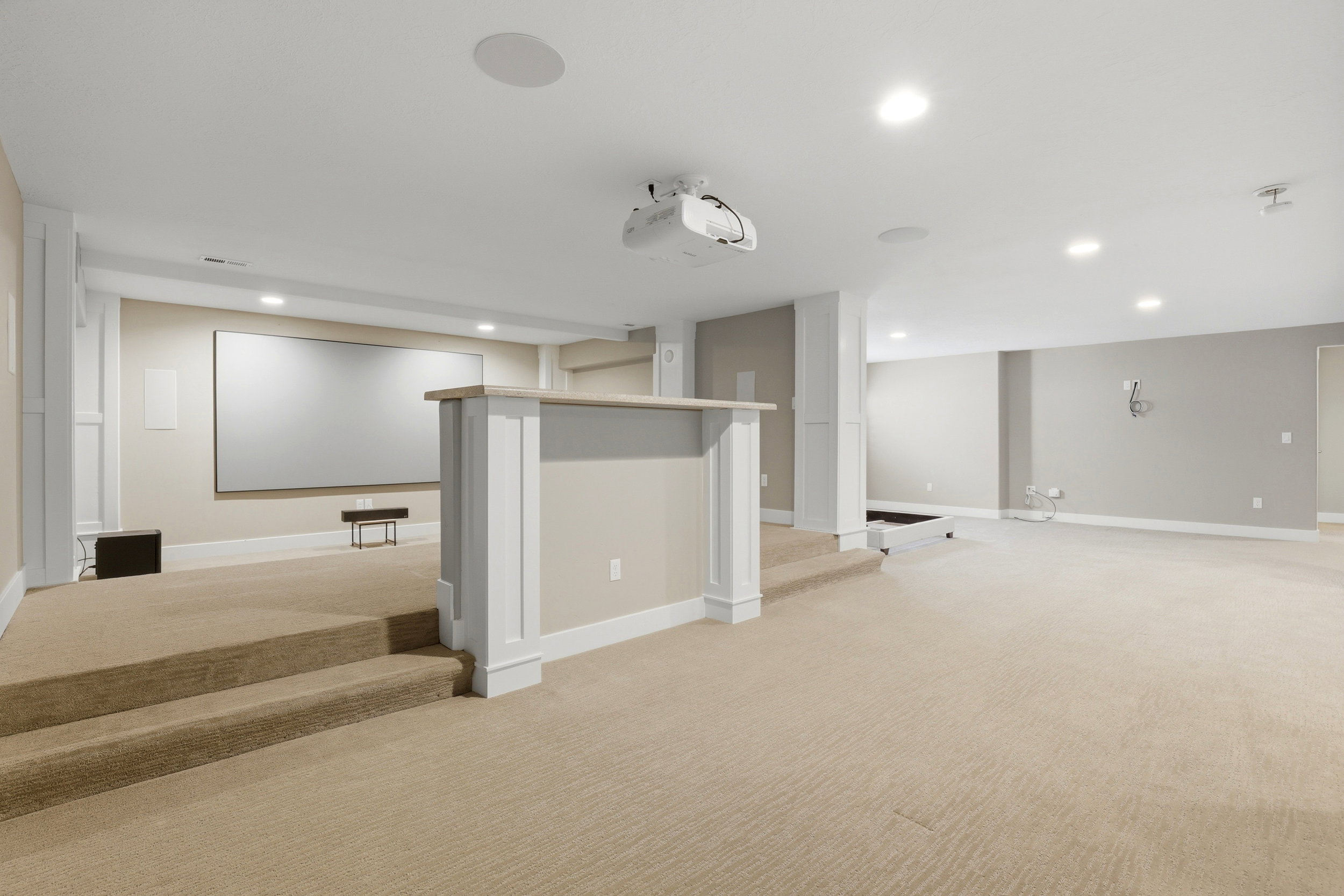 Finished below grade area with light carpet and recessed lighting