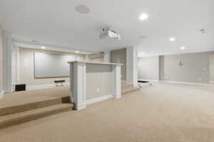 Finished below grade area with light carpet and recessed lighting