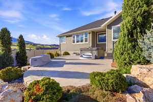 View of patio featuring a mountain view and a hot tub
