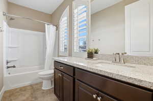 Full bath with vanity and shower / bath combo with shower curtain
