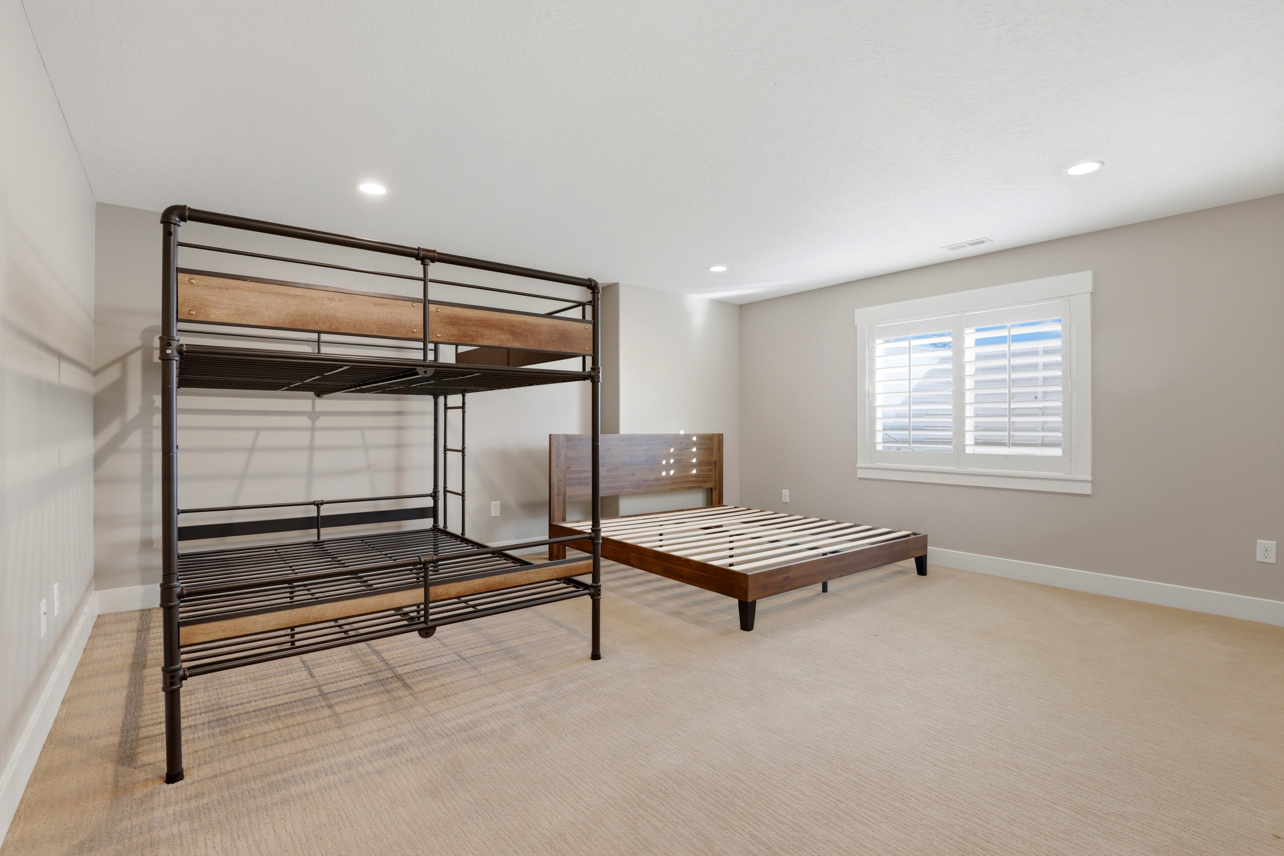 Bedroom with light colored carpet and recessed lighting