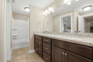 Bathroom featuring double vanity and  shower combination