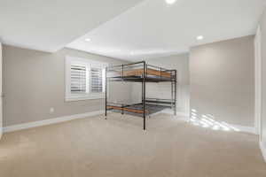 Bedroom featuring light colored carpet and recessed lighting
