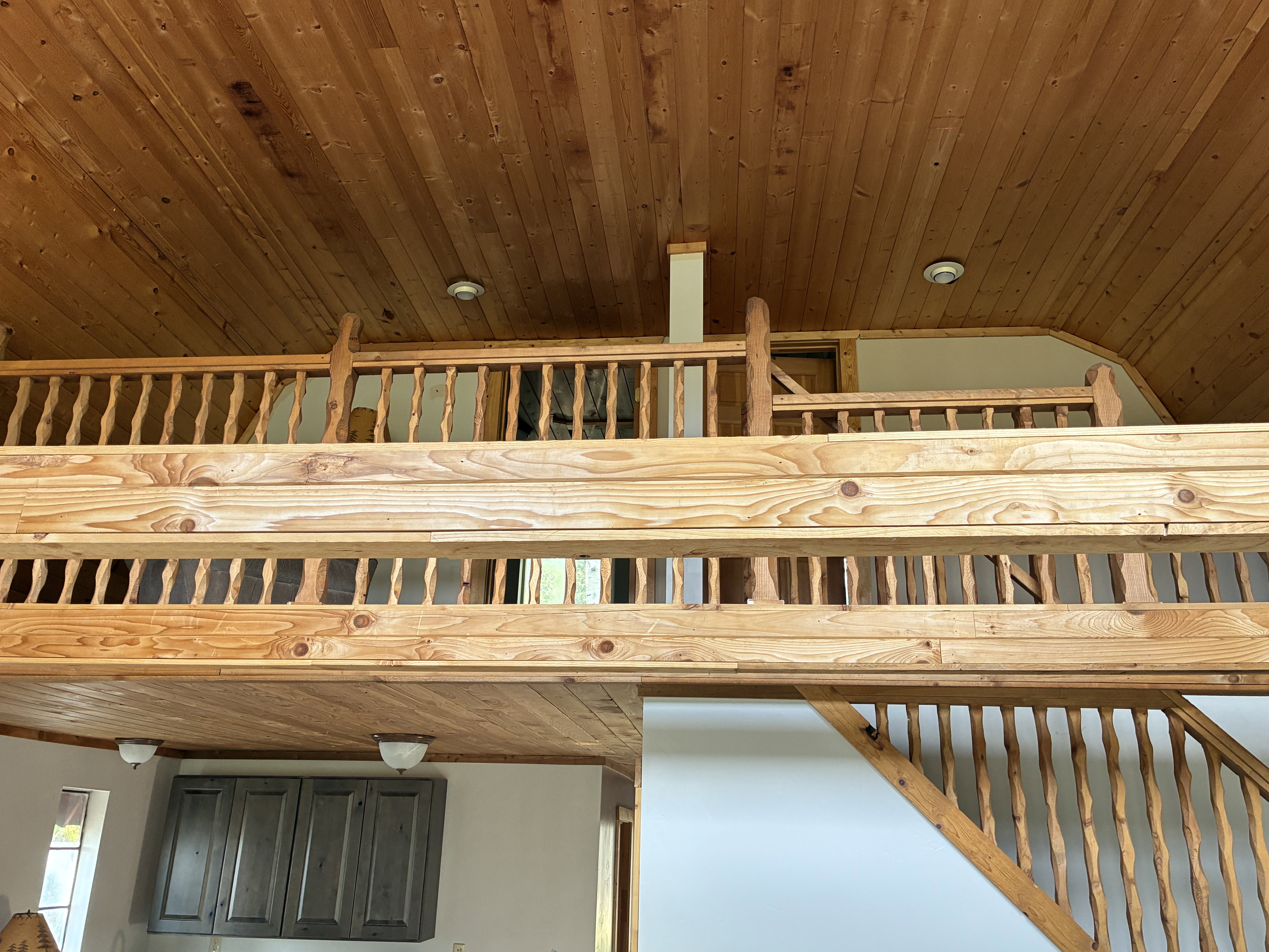 View of loft with two bedrooms connected to loft.