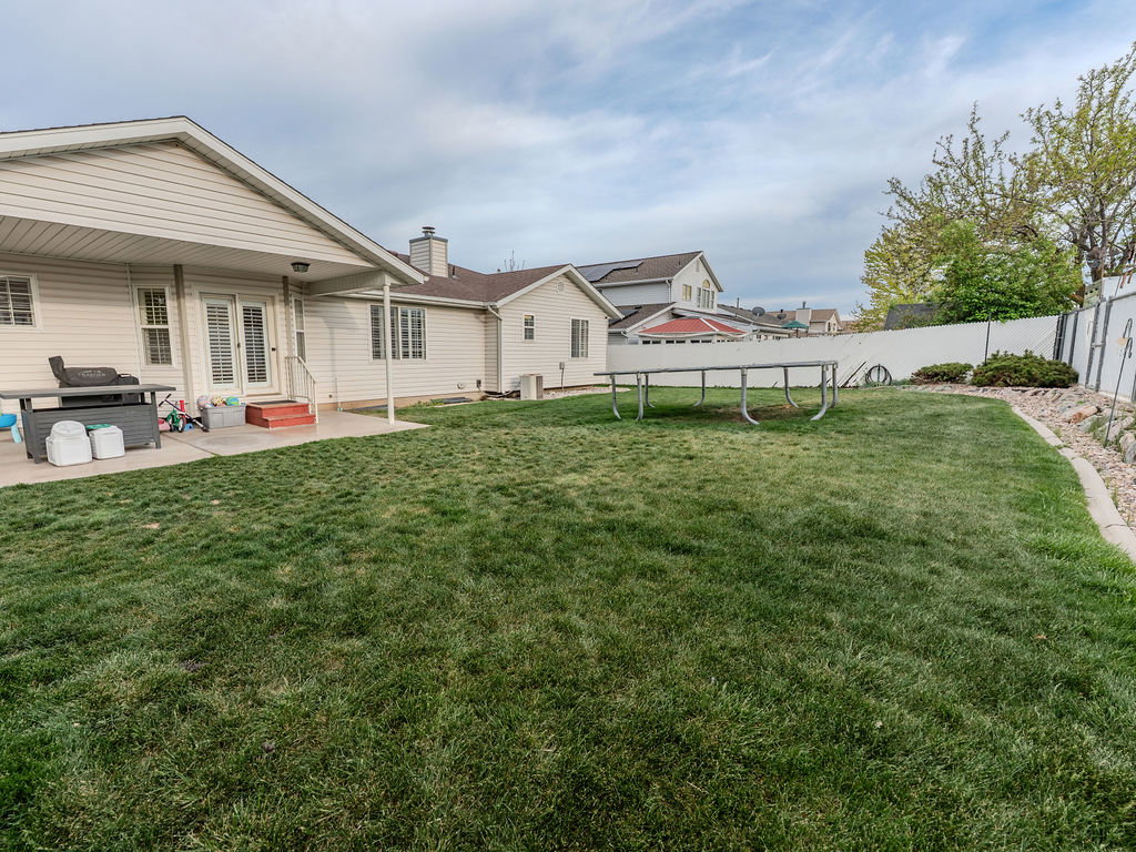 Fenced backyard featuring a patio area, french doors, and entry steps