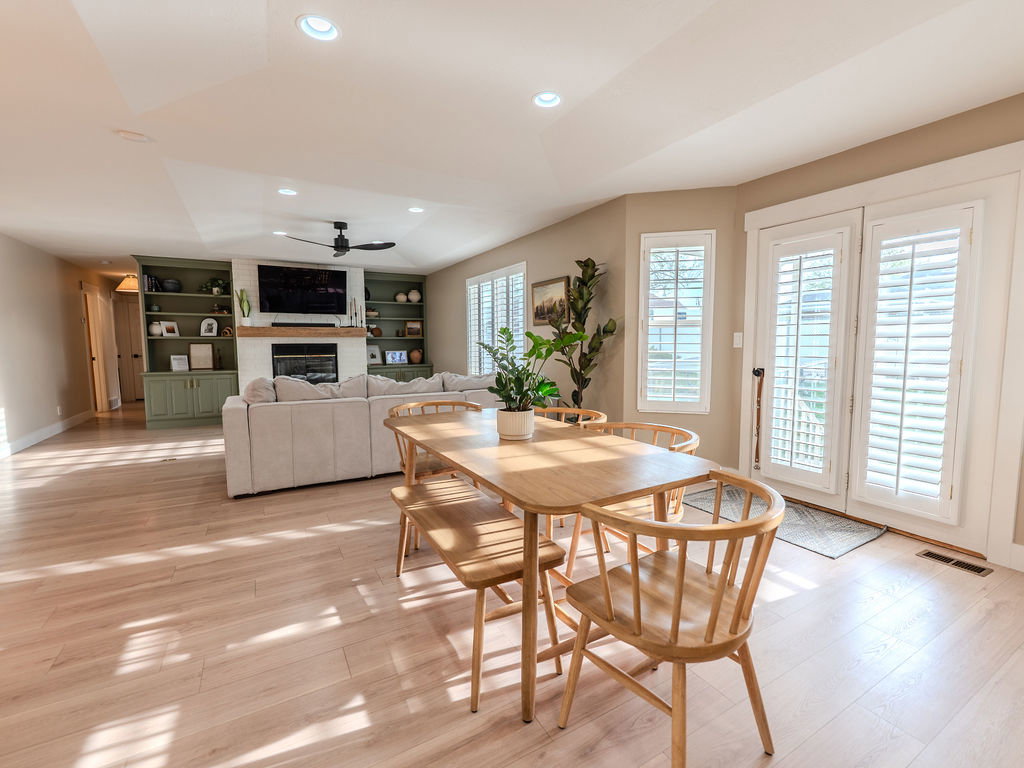 Dining room featuring built in features, light wood-style floors, recessed lighting, a ceiling fan, and a fireplace