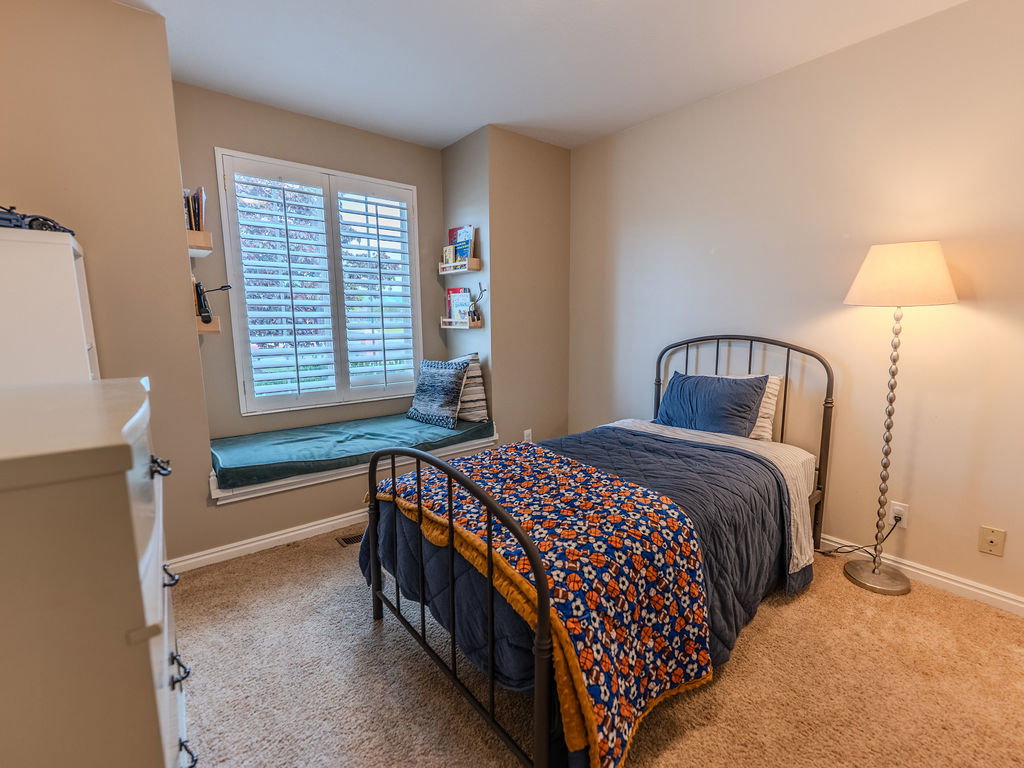 Bedroom featuring light carpet