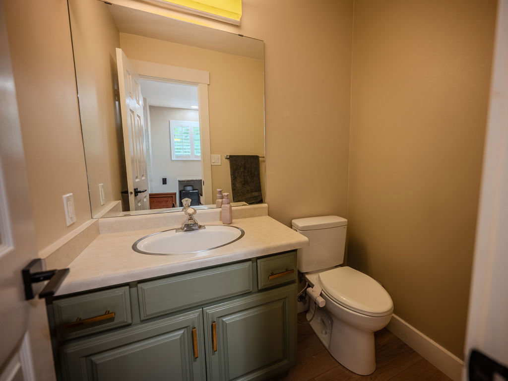 Half bath featuring vanity and dark wood-style floors