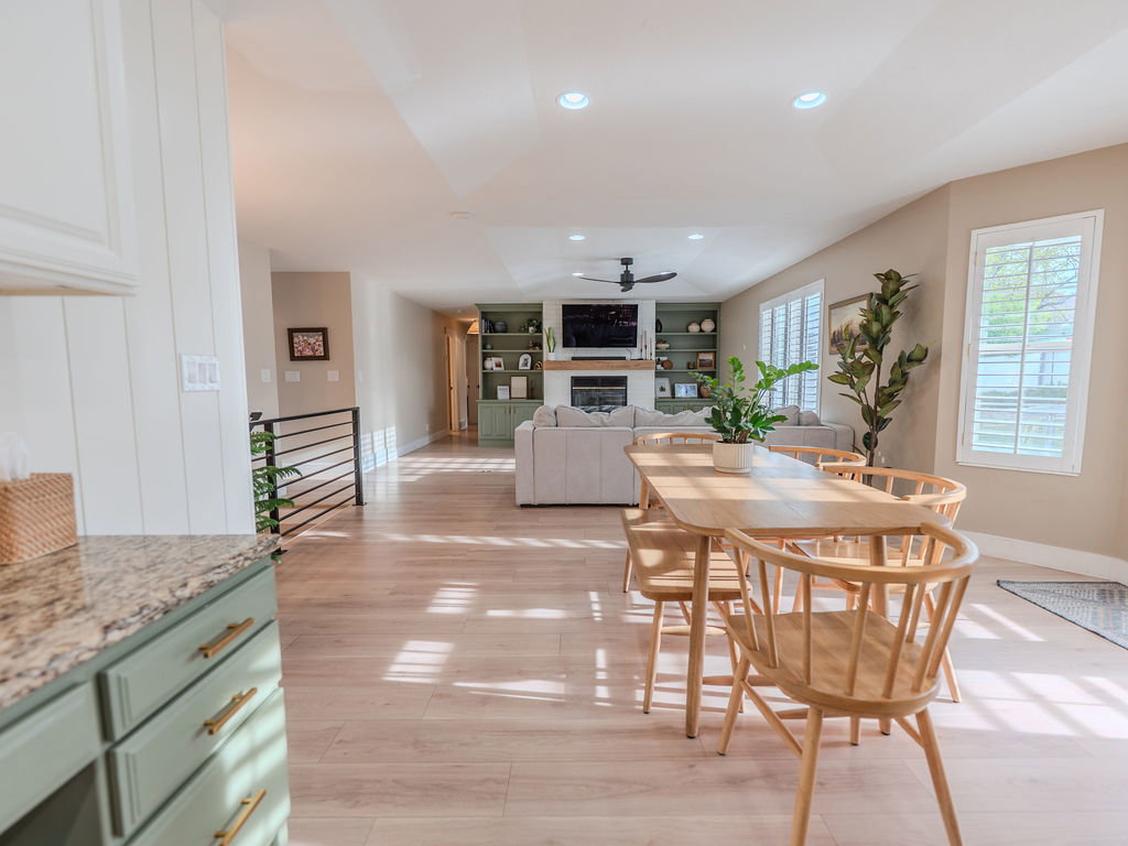 Dining room with recessed lighting, light wood-type flooring, a ceiling fan, a fireplace, and built in features