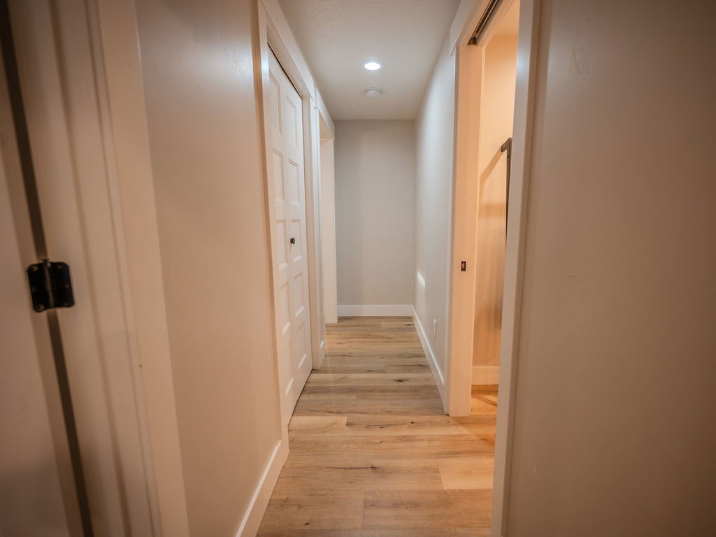Corridor with light wood-style floors and recessed lighting