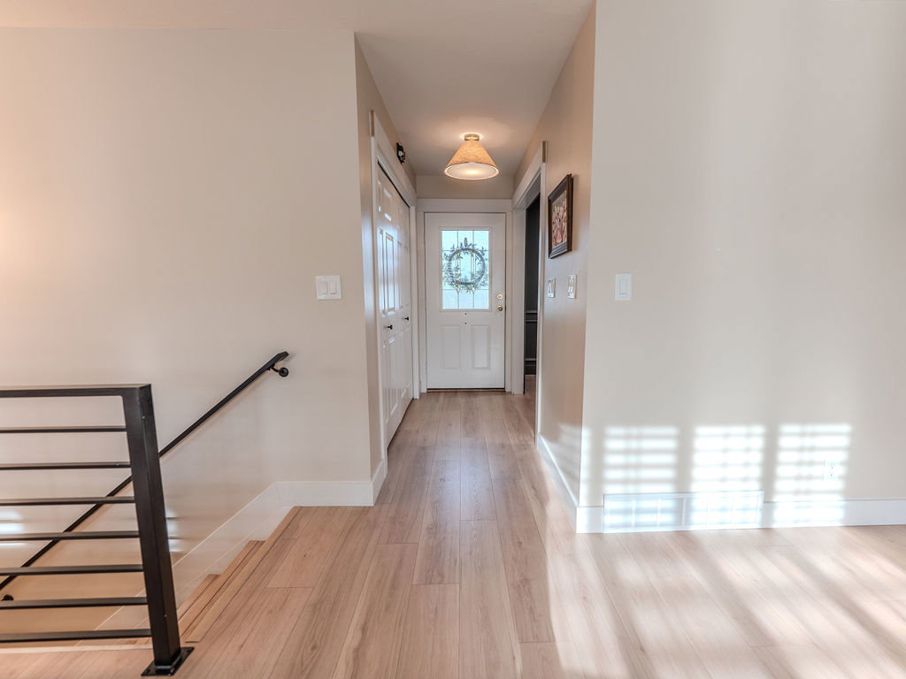 Doorway to outside with wood finished floors and baseboards
