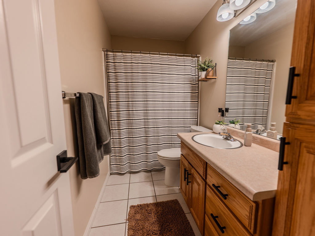 Full bath featuring vanity and light tile patterned floors