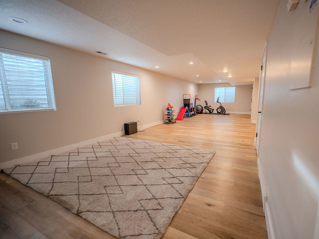 Playroom with light wood-type flooring and recessed lighting