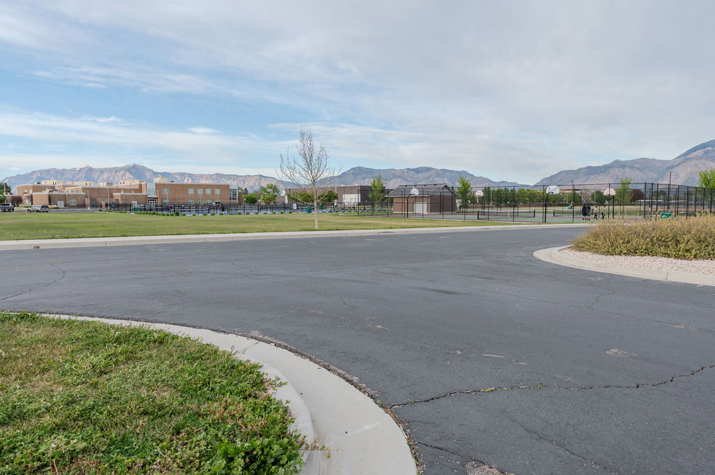 View of asphalt road with a mountain view and curbs