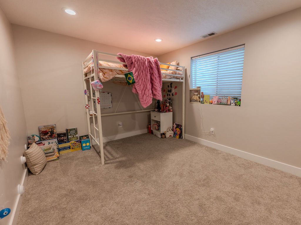 Bedroom featuring light colored carpet and recessed lighting