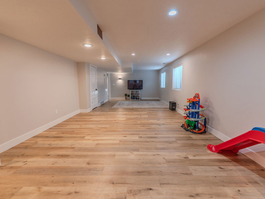 Playroom with light wood-style flooring and recessed lighting