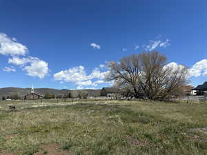 View of yard featuring a view of rural / pastoral area and a mountain view