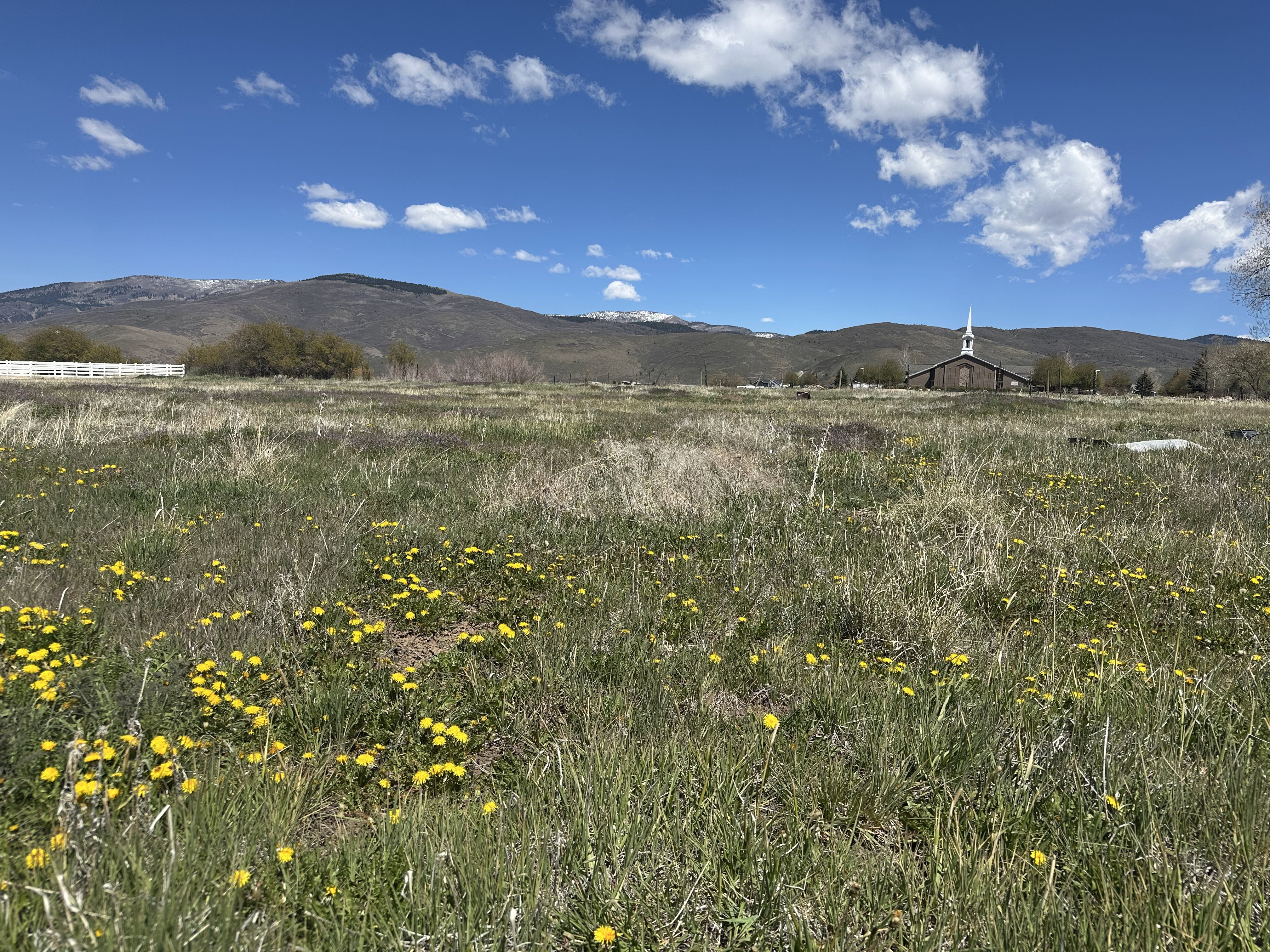 View of mountain backdrop with rural landscape
