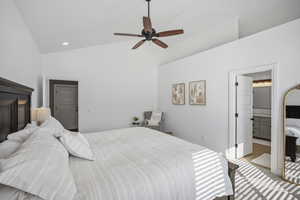 Main-level primary suite, with vaulted ceilings, fresh neutral paint, and backyard views