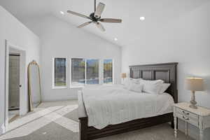 Main-level primary suite, with vaulted ceilings, fresh neutral paint, and backyard views