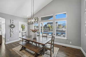 Large dining area off the kitchen with a wall of windows overlooking the backyard