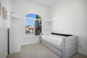 Bedroom with a wainscoted wall and large sunny window