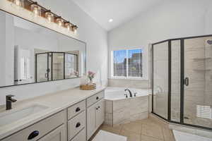 The spa-inspired bath features an oversized, newly tiled shower, a corner jetted tub, quartz countertops, a private water closet, and a spacious walk-in closet
