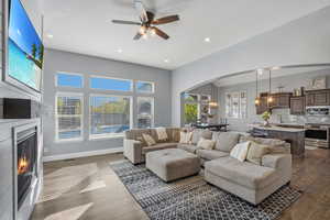 Open great room with a wall of windows overlooking the back yard.  Custom built ins and shiplap fireplace