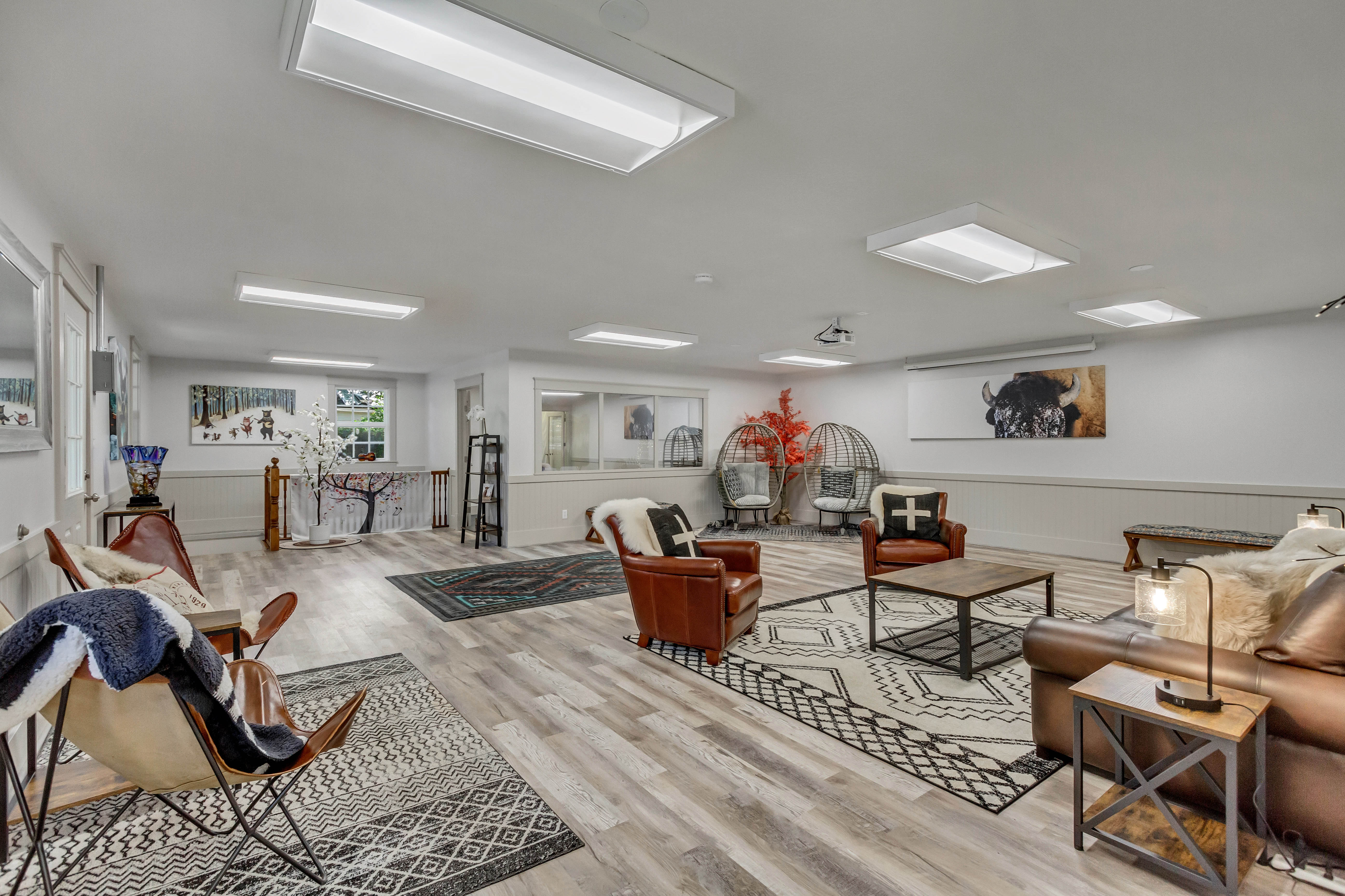 Living room with light wood finished floors and a wainscoted wall