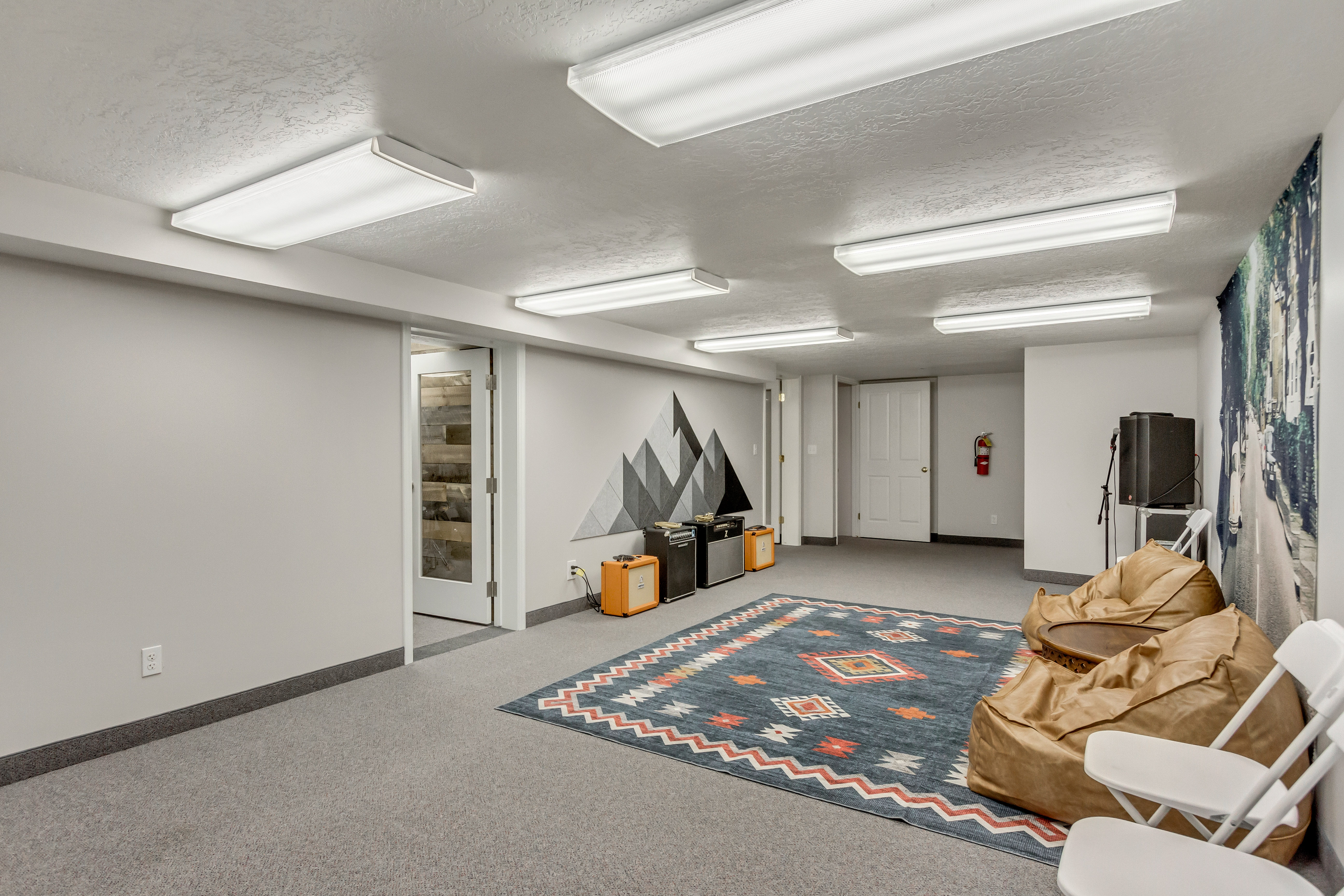 Finished below grade area featuring a textured ceiling and light colored carpet