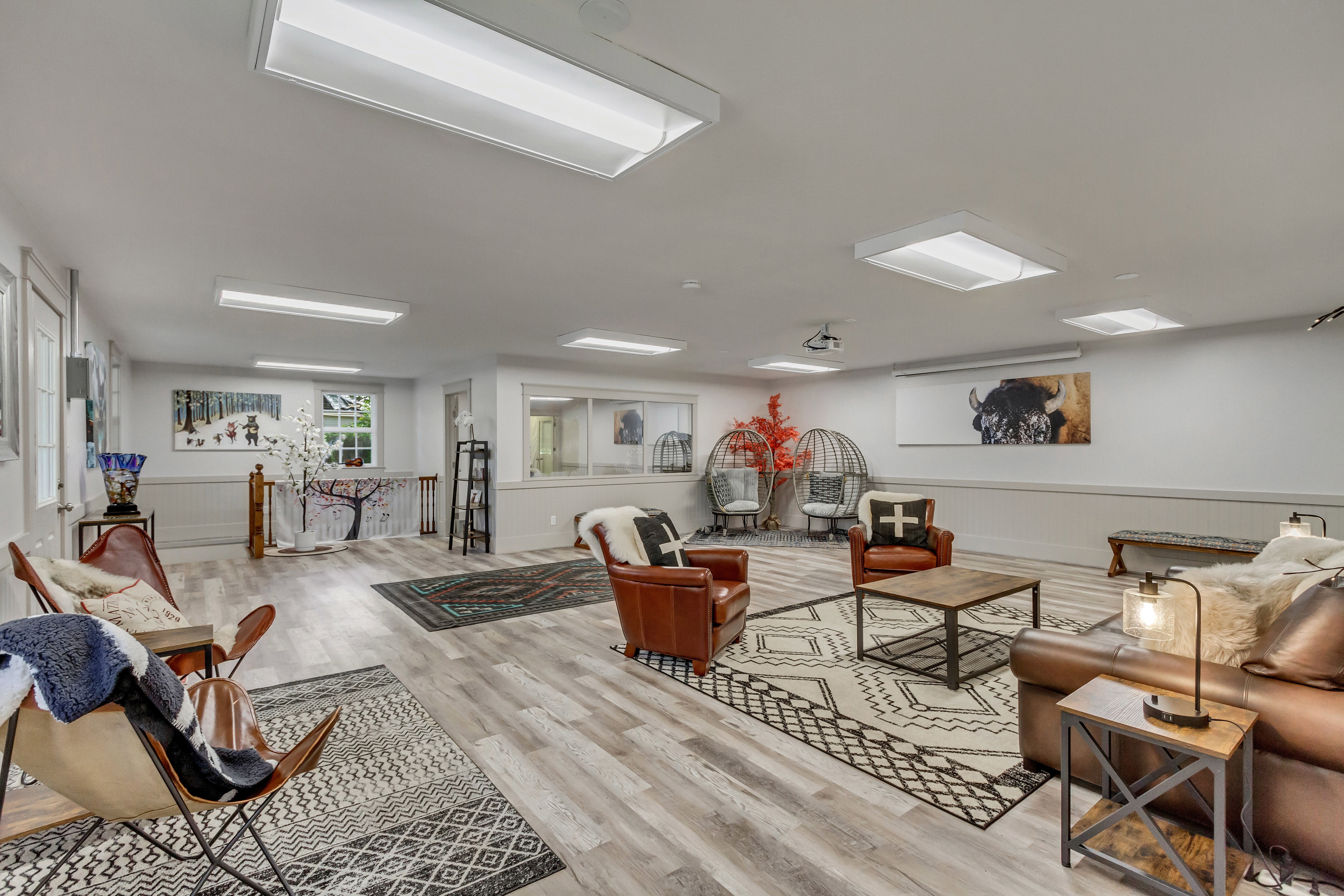 Living room with light wood finished floors and a wainscoted wall