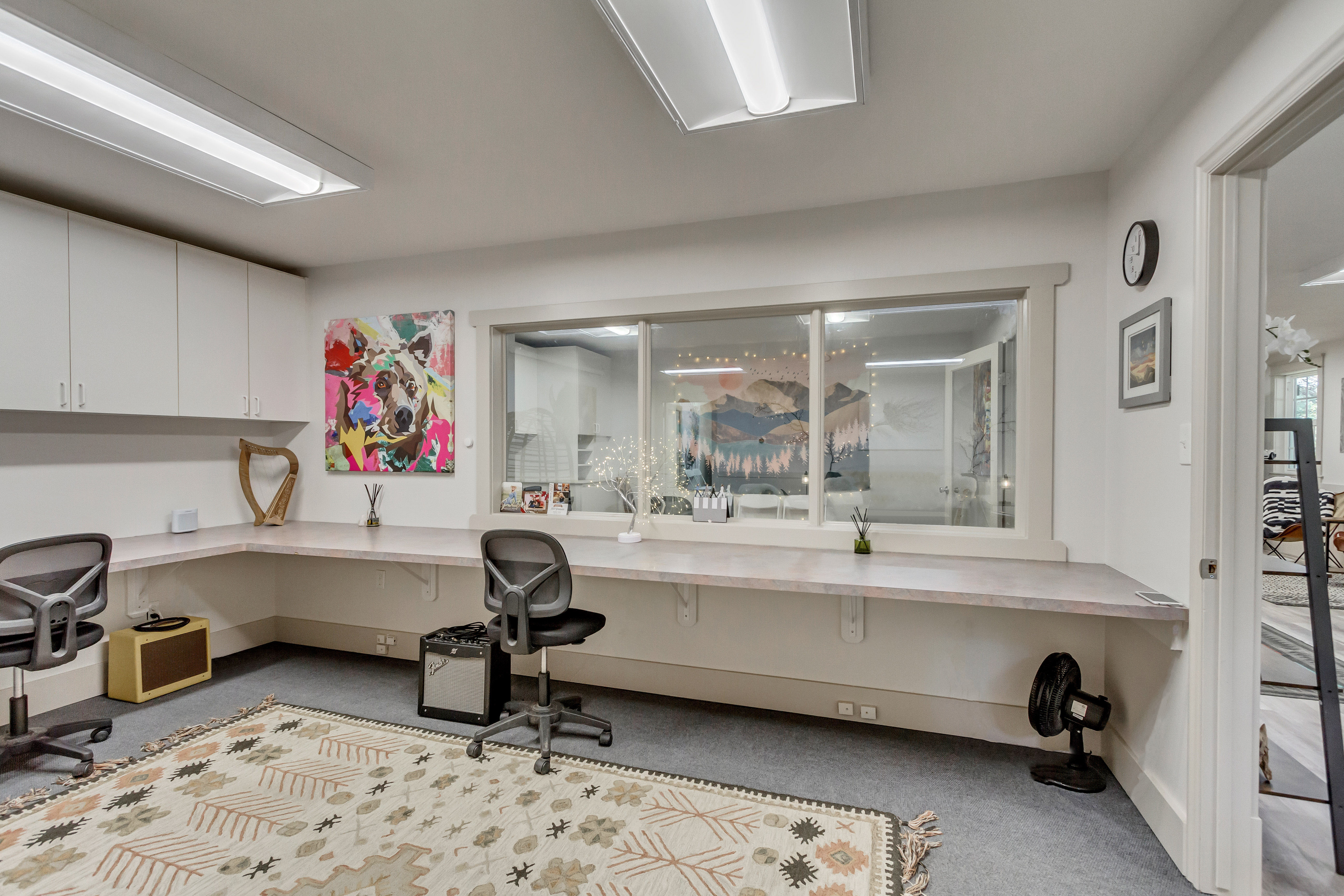 Office featuring built in desk and light colored carpet