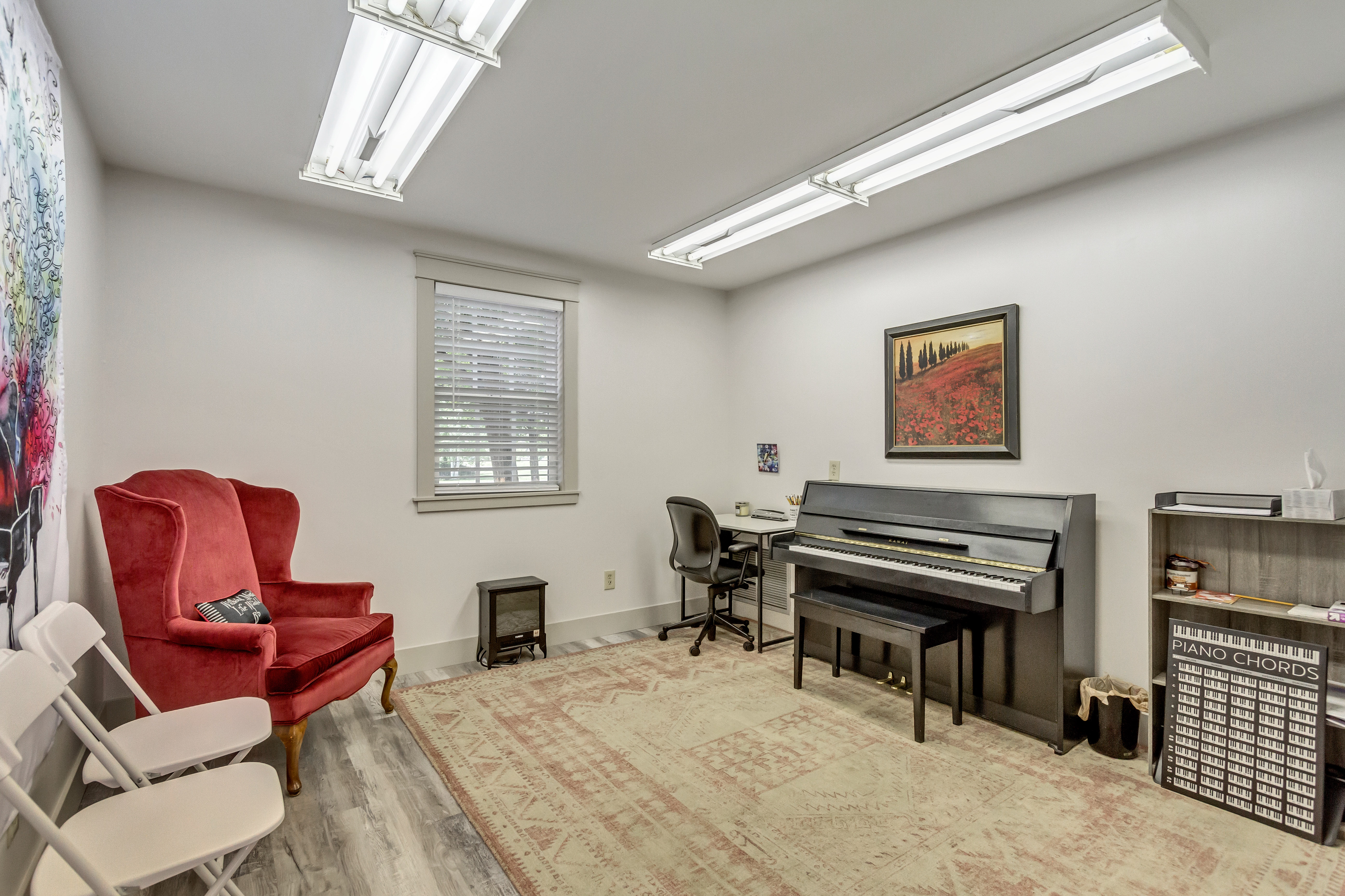 Home office with light wood-style floors and baseboards