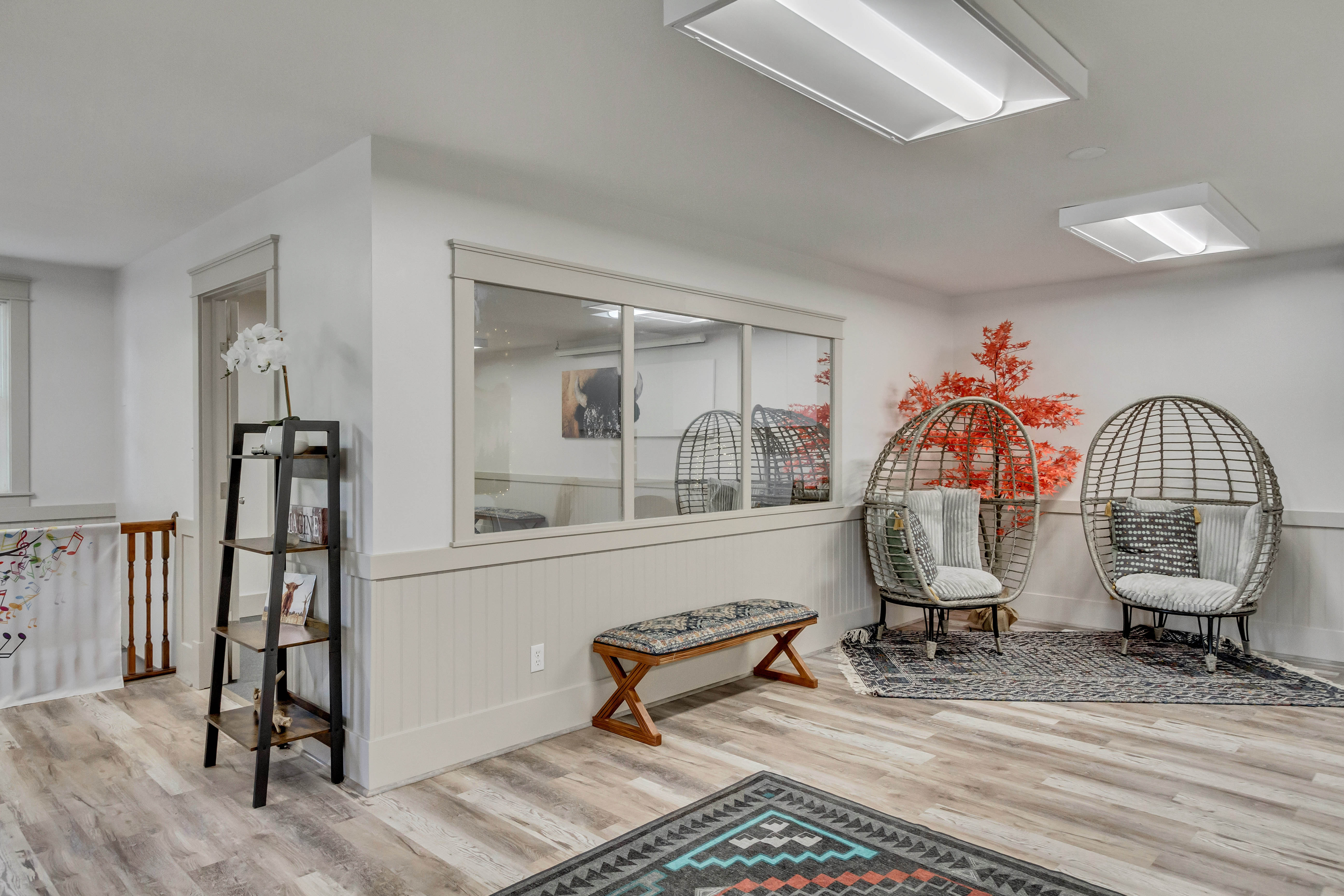 Living area with wainscoting and light wood-type flooring