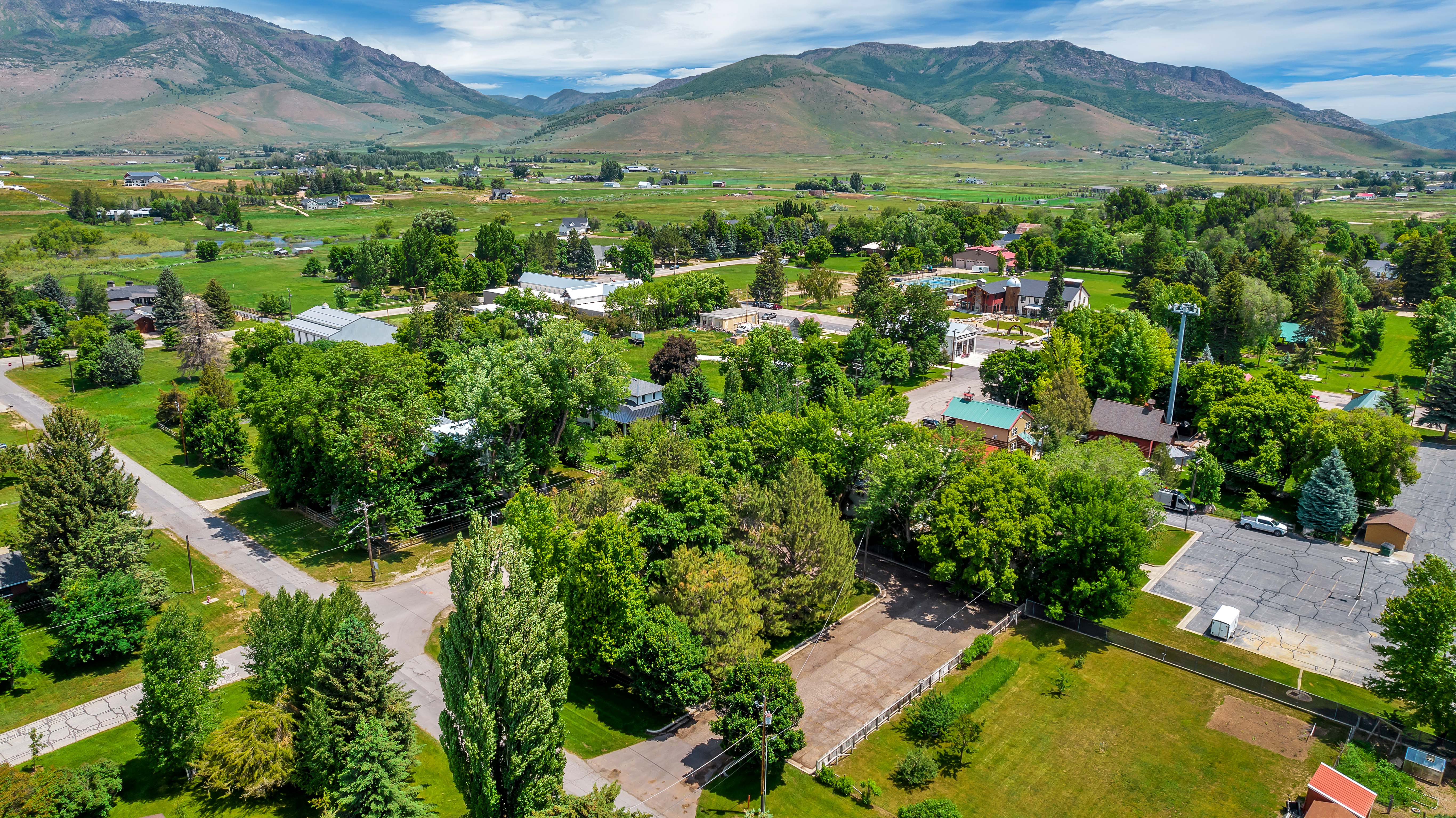 Aerial perspective of suburban area featuring a mountain backdrop