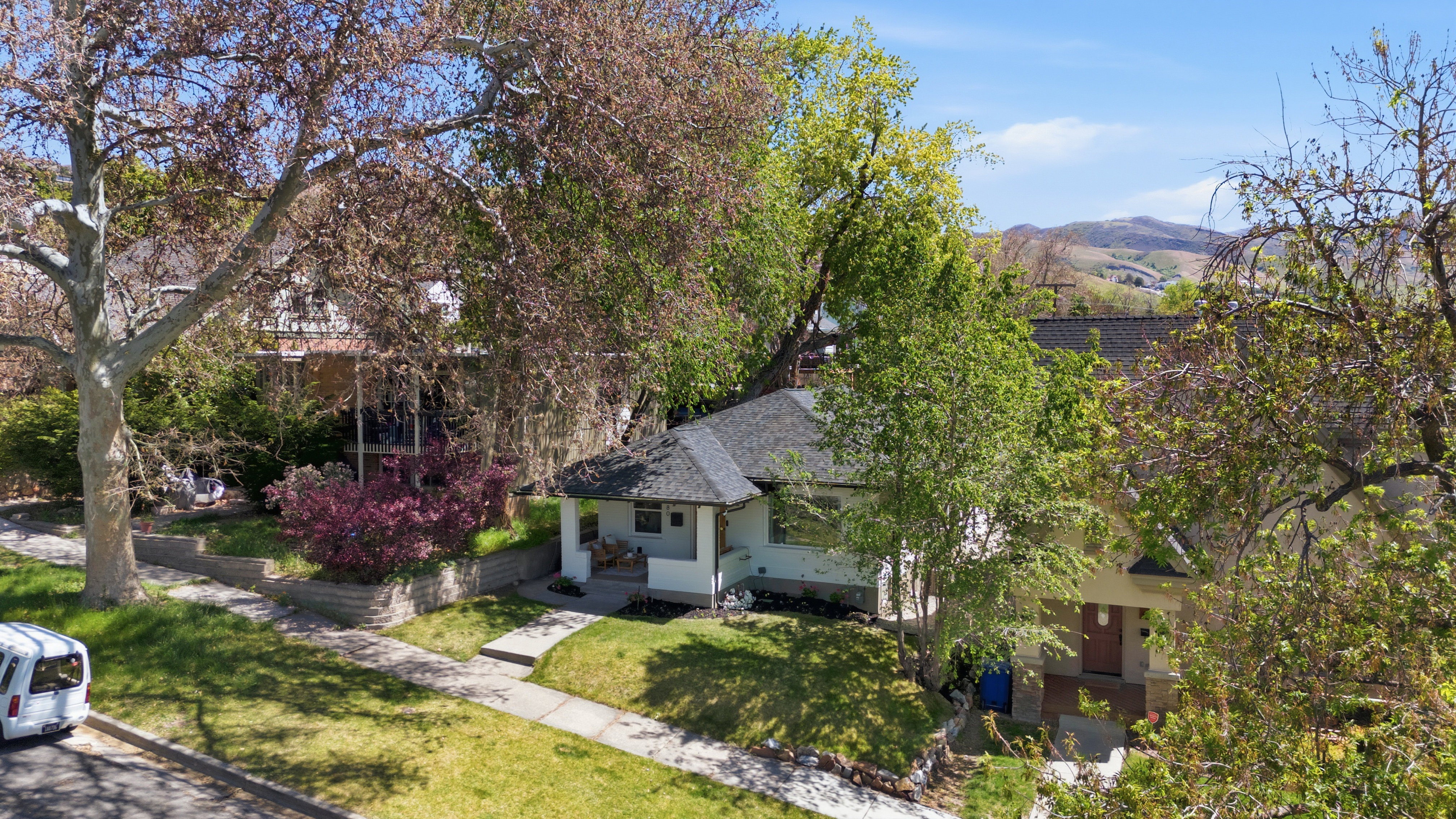 Aerial view of property and surrounding area featuring mountains