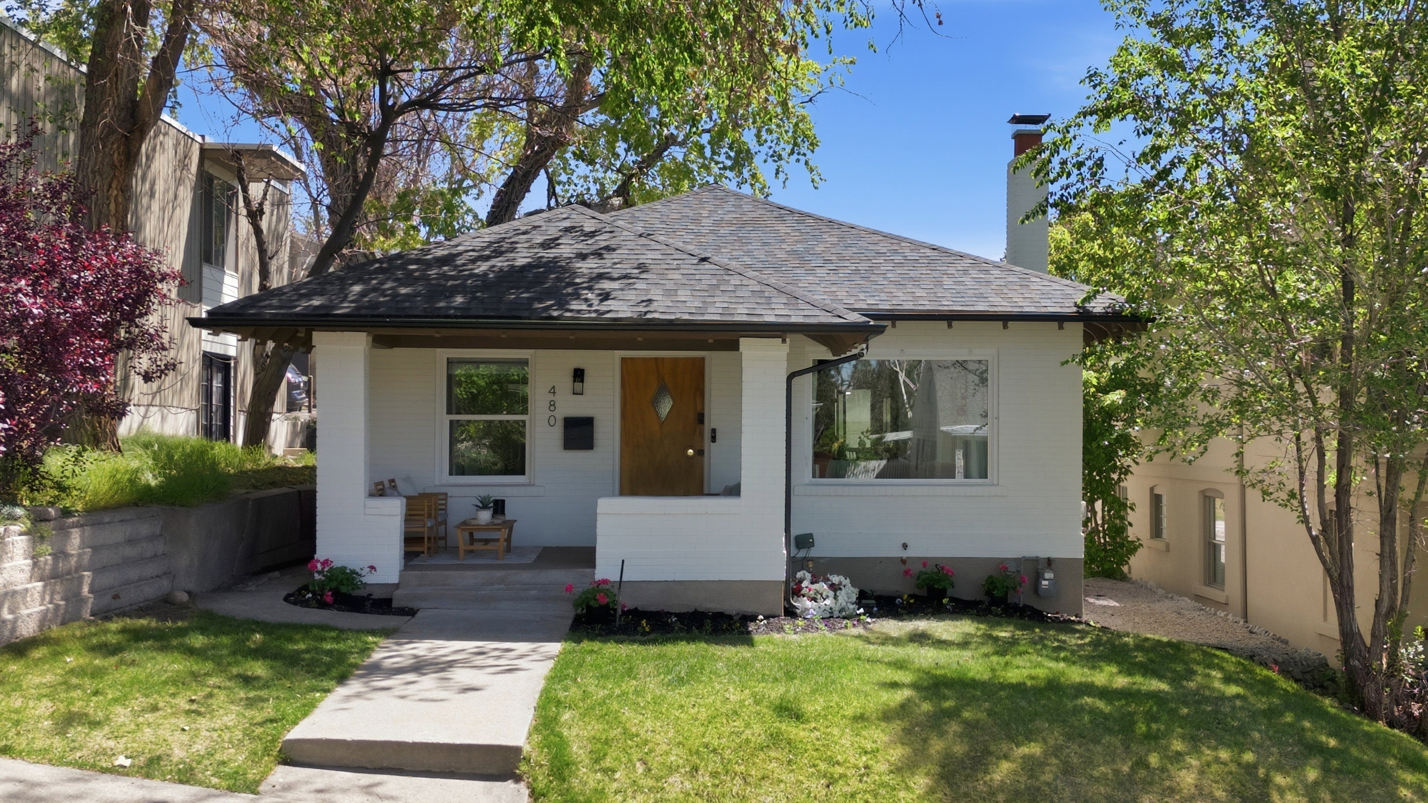 View of front of home featuring a porch, a new shingled roof, brick siding, and a front yard