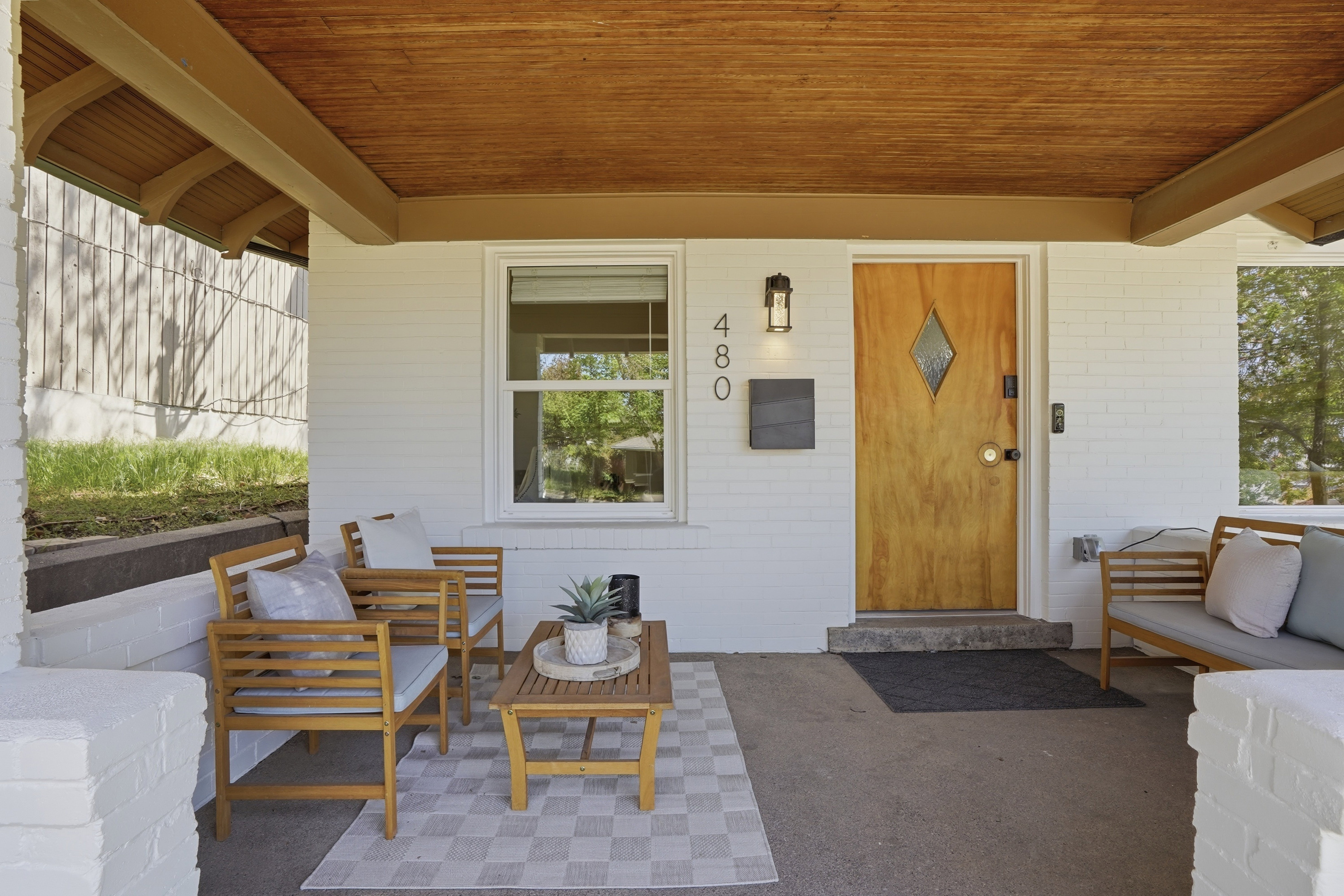 Doorway to property with outdoor lounge area, a patio, and brick siding