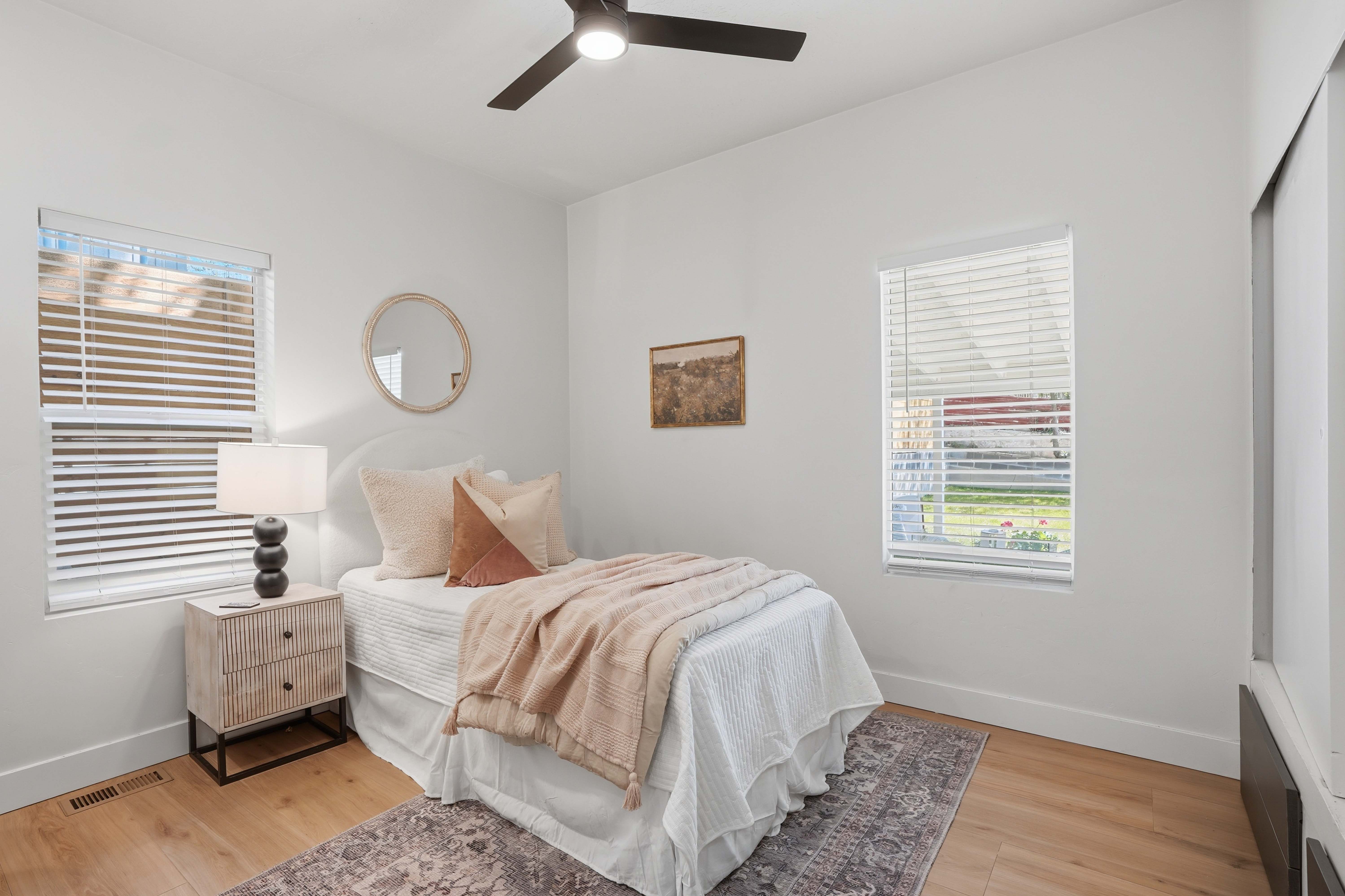 Bedroom featuring multiple windows, and ceiling fan