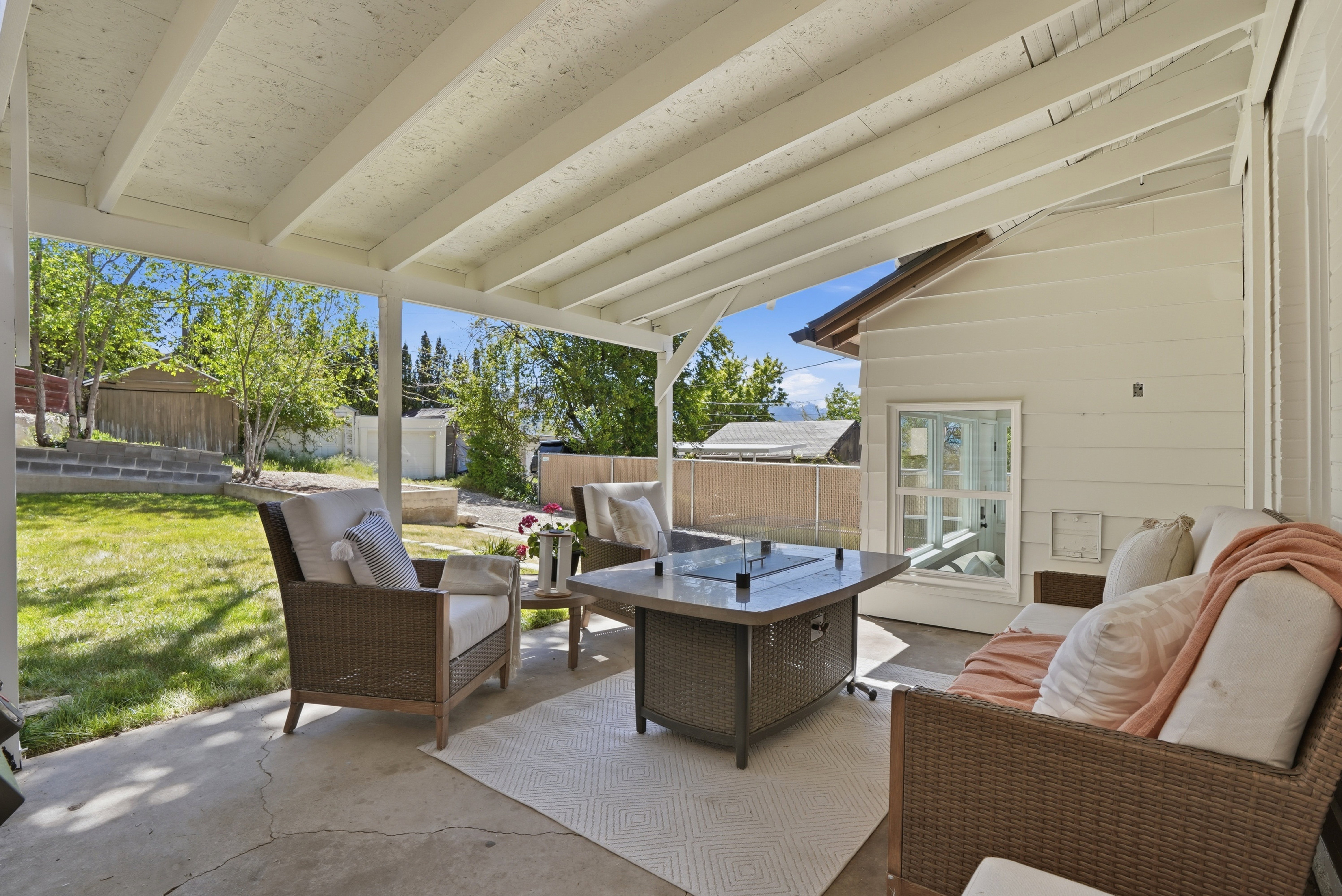 Fenced backyard with an outdoor hangout area, a patio, and an outdoor structure