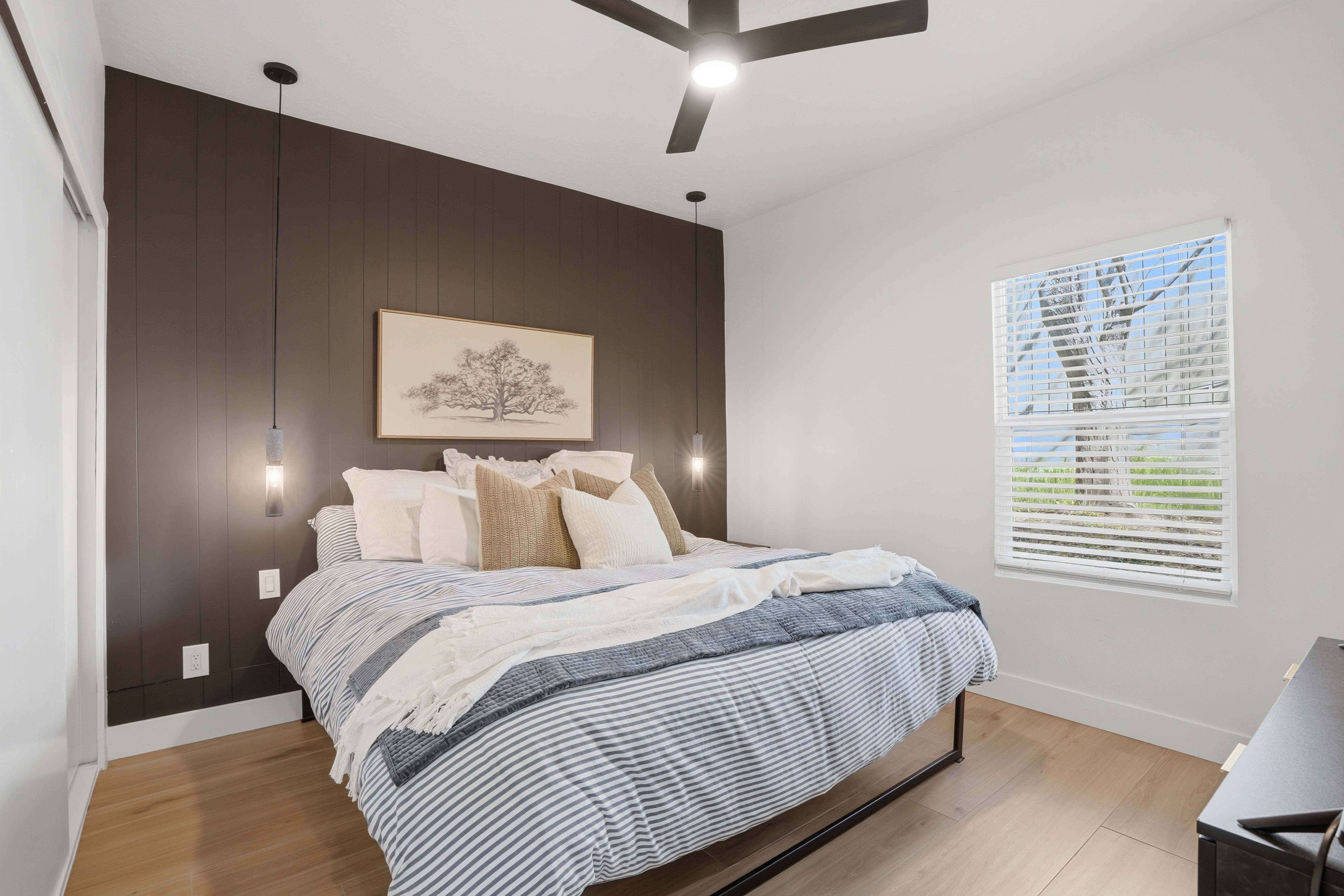 Bedroom featuring light wood-type finished floors, and ceiling fan