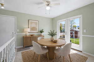 Dining space featuring a ceiling fan, french doors, and radiator