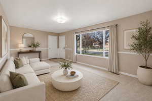 Living room featuring light carpet and baseboards